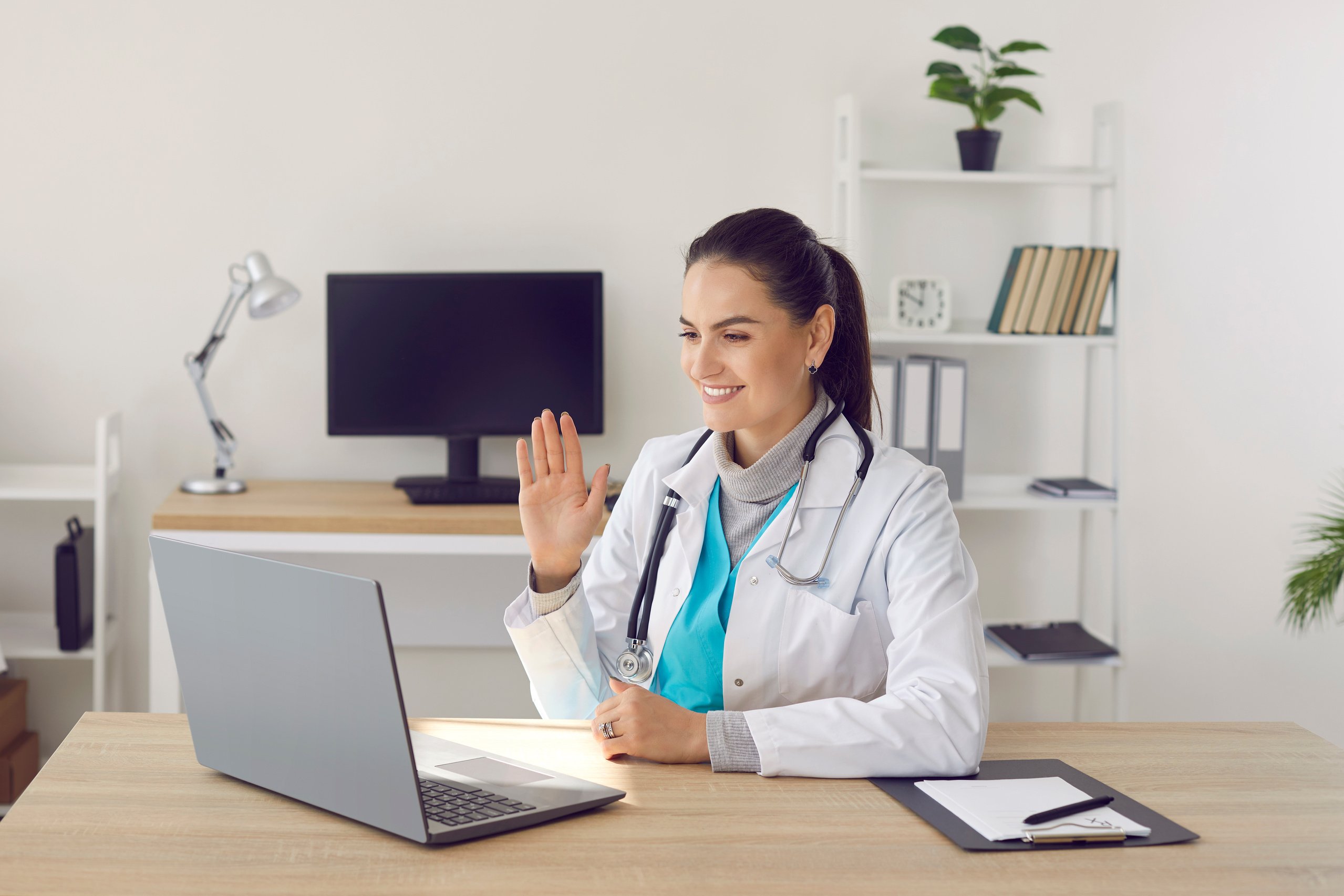 Friendly Young Female Doctor Provides Online Consultation to Patient via Video Link.